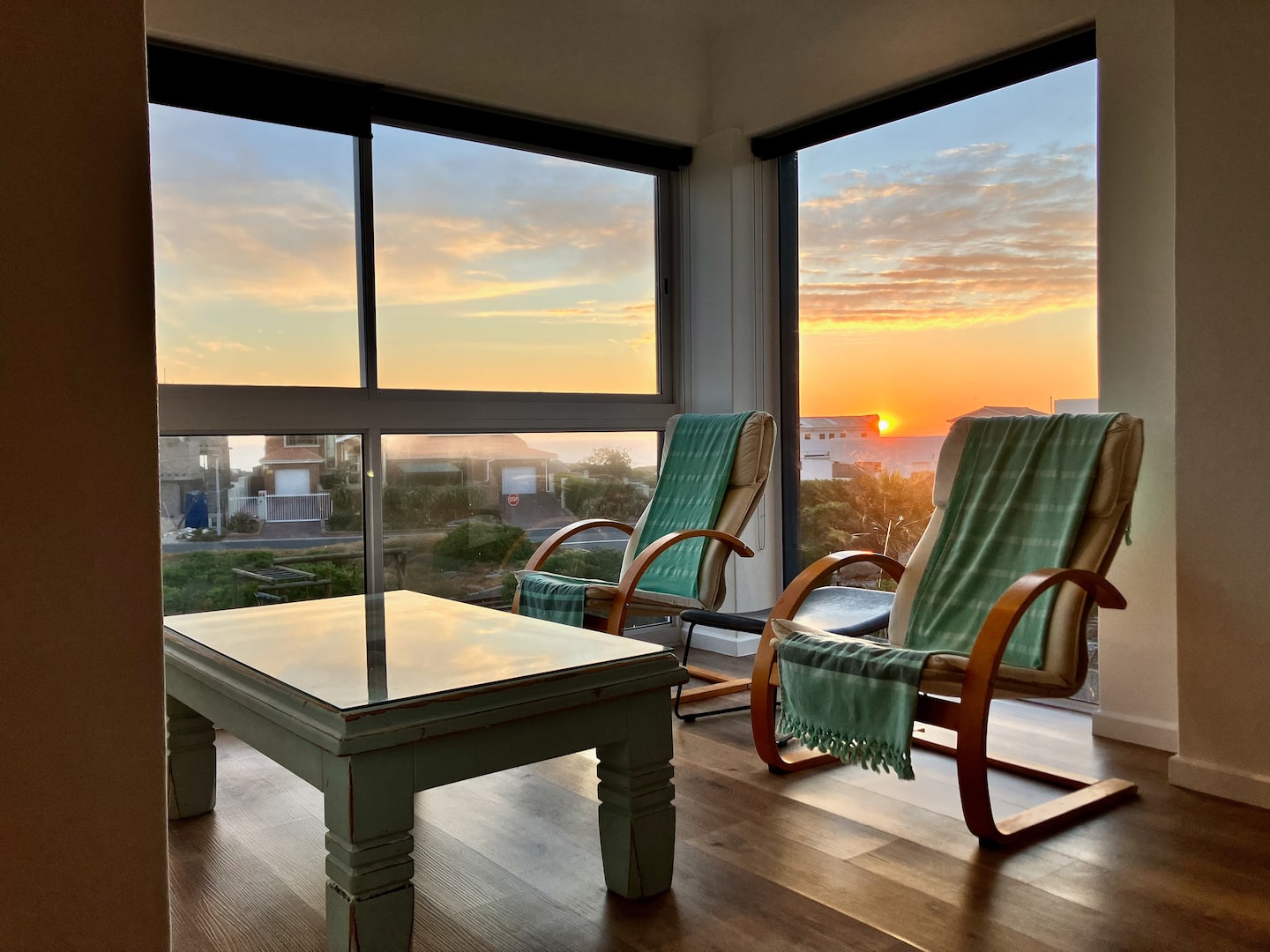 Lounge chairs looking out over the ocean at sunset